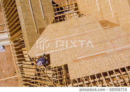 Builder on working a new roof in unfinished house Builder on working a new roof in unfinished house 88508719