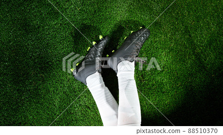 Soccer player legs on grass, top shot. 88510370