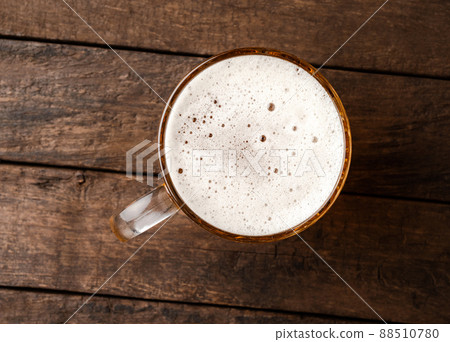 Beer glass on an old wooden table. Top view 88510780