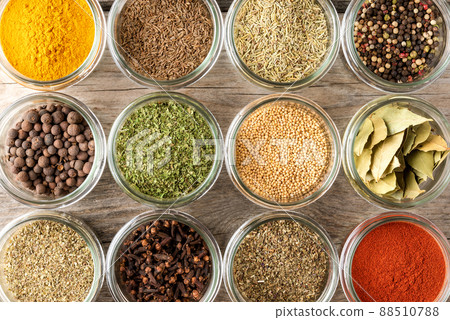 Mix of colourful spices in bowls on wooden table. Collection of seasonings. Top view Mix of colourful spices in bowls on wooden table. Collection of seasonings. Top view 88510788