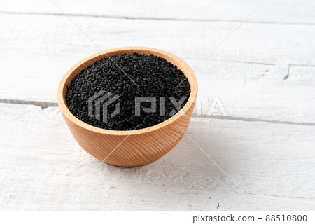 Black cumin seeds in bowl on vintage wooden background 88510800