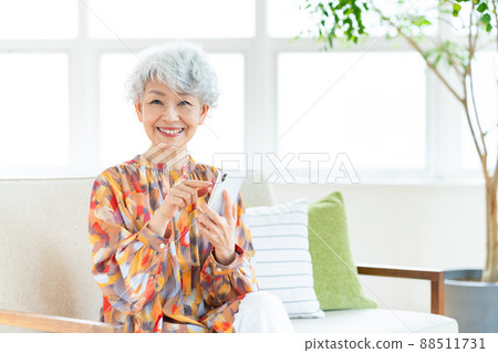 看智能手機的資深婦女 看智能手機的資深婦女 88511731