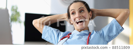 Cheerful doctor chilling at work 88511809