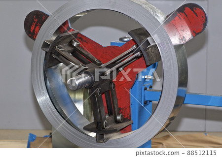 Thin galvanized metal tape in a roll on the drum Thin galvanized metal tape in a roll on the drum 88512115