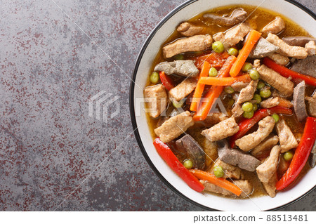 Pork Igado is an Ilocano stew made of strips of liver and pork tenderloin braised in a tangy and savory soy sauce closeup in the plate. Horizontal top view 88513481