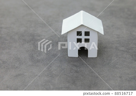 Simply design with miniature white toy model house on concrete stone grey background. Mortgage property insurance dream home concept. Copy space 88516717