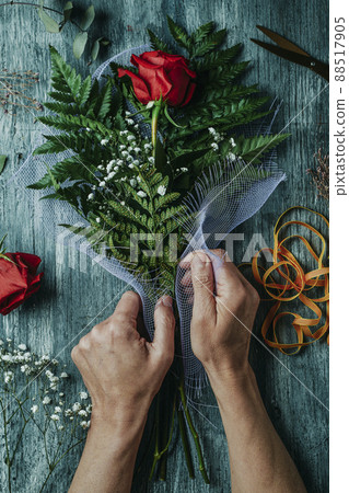 arranging a bouquet with a red rose for Sant Jordi arranging a bouquet with a red rose for Sant Jordi 88517905