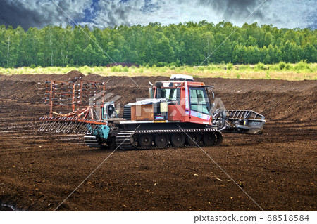 Mining and extraction of peat with a tracked vehicle in a bog area 88518584