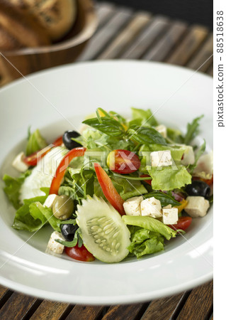 organic fresh greek salad with feta cheese on wood table 88518638