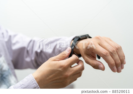 A man wears a watch. Wears a watch before going to work. A man wears a watch. Wears a watch before going to work. 88520011