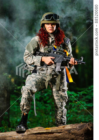 Ukranian female soldier in the forest 88520080