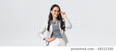 Business, finance and employment, female successful entrepreneurs concept. Confident businesswoman in glasses and white suit ready for meeting, smiling pleased, standing determined Business, finance and employment, female successful entrepreneurs concept. Confident businesswoman in glasses and white suit ready for meeting, smiling pleased, standing determined 88522380
