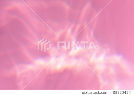 Beautiful lights and shadows of glass on pink or purple background. Overlay mode. Caustic effect of light. Sun hard reflection. Shadows texture. Blurred water backdrop. Top view. Trendy concept 88523434