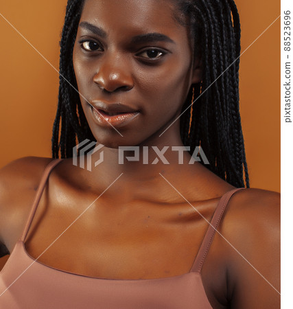 pretty young african american woman with braids posing cheerful gesturing on brown background, lifestyle people concept pretty young african american woman with braids posing cheerful gesturing on brown background, lifestyle people concept 88523696