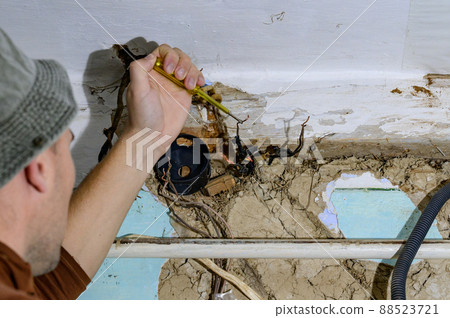 Old electrical wiring in the house, wooden walls in the house, replacement of electrical cables. Old electrical wiring in the house, wooden walls in the house, replacement of electrical cables. 88523721