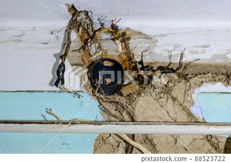 Old electrical wiring in the house, wooden walls in the house, replacement of electrical cables. Old electrical wiring in the house, wooden walls in the house, replacement of electrical cables. 88523722