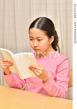 A girl reading a book A girl reading a book 88525545