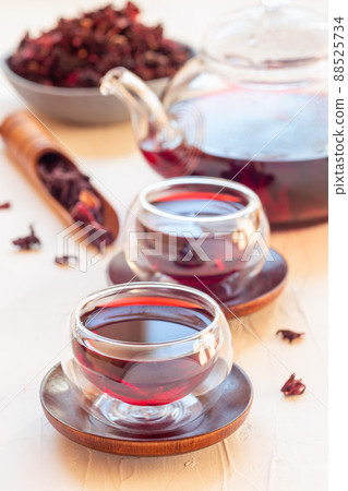 Red tea karkade or hibiscus in glass cups and glass tea pot, vertical Red tea karkade or hibiscus in glass cups and glass tea pot, vertical 88525734