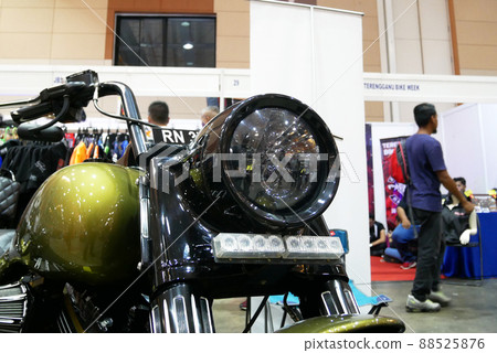 SELANGOR, MALAYSIA - 8 APRIL 2022: Branded motorcycle classic headlights installed on custom motorcycles. The motorcycle was displayed to the public in a large showroom. SELANGOR, MALAYSIA - 8 APRIL 2022: Branded motorcycle classic headlights installed on custom motorcycles. The motorcycle was displayed to the public in a large showroom. 88525876