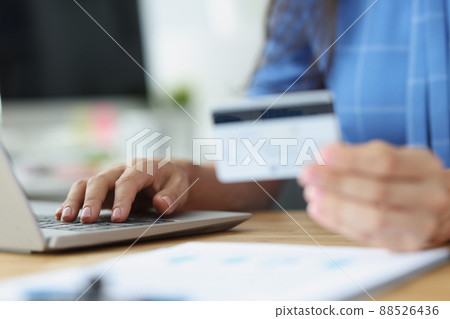 Credit bank card in hand and computer keyboard Credit bank card in hand and computer keyboard 88526436