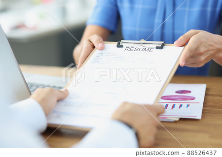 Person submits resume to an employer at interview 88526437