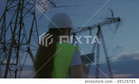 woman power engineer helmet with tablet her hands works. governing body of electricity industry. electrical engineer job concept. young female electrician network repairman. electric tower business. 88526785