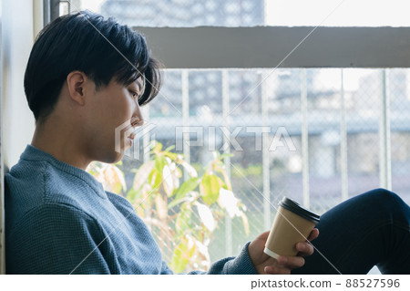 Young man sitting on the floor 88527596