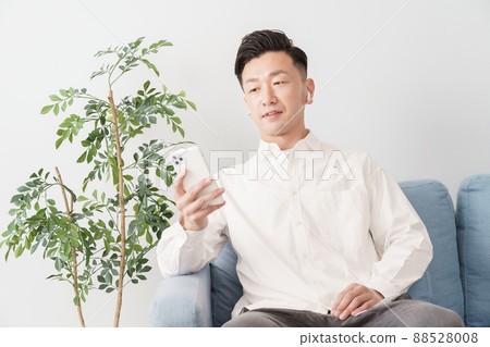 man looking at smartphone screen man looking at smartphone screen 88528008