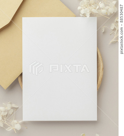Blank greeting card invitation Mockup 5x7 on envelope with dry flowers and ribbon on paper background, flat lay, mockup Blank greeting card invitation Mockup 5x7 on envelope with dry flowers and ribbon on paper background, flat lay, mockup 88530487