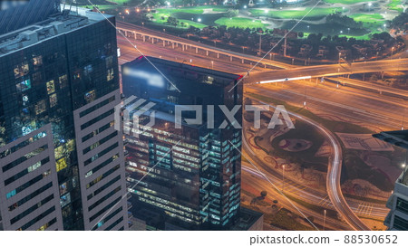 Crossroad junction between golf course and Dubai Marina intersected by Sheikh Zayed Road aerial night timelapse. Crossroad junction between golf course and Dubai Marina intersected by Sheikh Zayed Road aerial night timelapse. 88530652