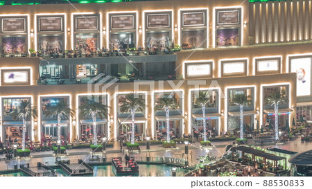 Shopping mall exterior with caffees and reastaurants night timelapse in Dubai, United Arab Emirates 88530833