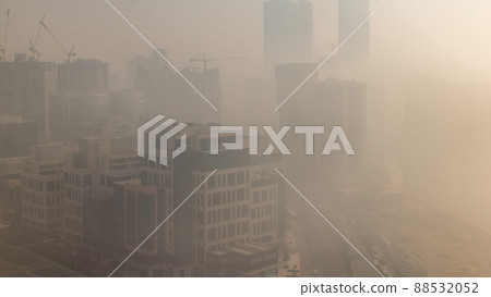 Modern city architecture in Business bay district during sunrise. Panoramic view of Dubai's skyscrapers foggy morning timelapse 88532052