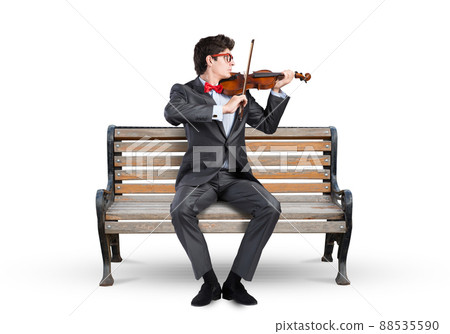 Young businessman plays the violin Young businessman plays the violin 88535590