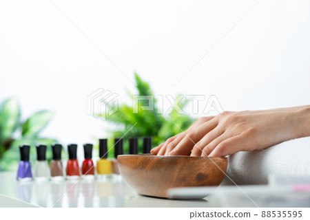 Woman hands in wooden bowl with water Woman hands in wooden bowl with water 88535595