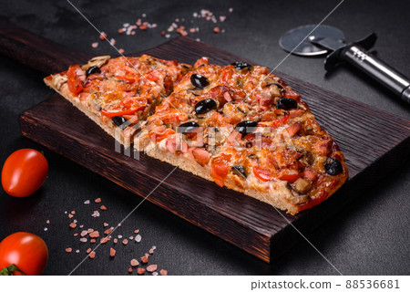 Homemade vegetable pizza with addition of tomatoes, olives and herbs 88536681