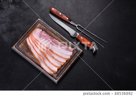 Slices of bacon on a wooden cutting Board. Pork meat Slices of bacon on a wooden cutting Board. Pork meat 88536892