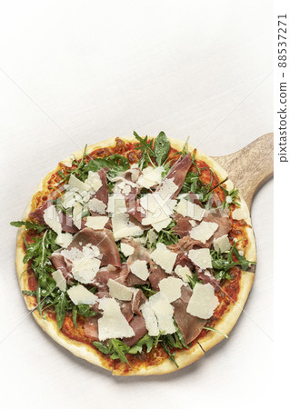 parma ham, rocket and parmesan cheese gourmet pizza on white background parma ham, rocket and parmesan cheese gourmet pizza on white background 88537271