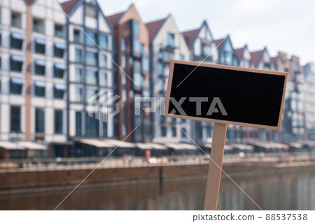 Blank Black billboard against new apartment building architecture in old town Gdansk Empty mockup template Blackboard label Gdansk Poland city. Travel to Poland Visit Gdansk Blank Black billboard against new apartment building architecture in old town Gdansk Empty mockup template Blackboard label Gdansk Poland city. Travel to Poland Visit Gdansk 88537538