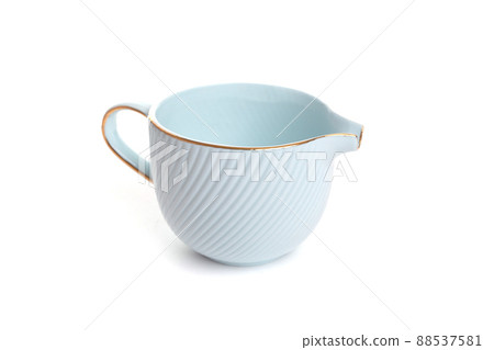 Stylish blue porcelain coffee creamer with golden rim and handle Stylish blue porcelain coffee creamer with golden rim and handle 88537581