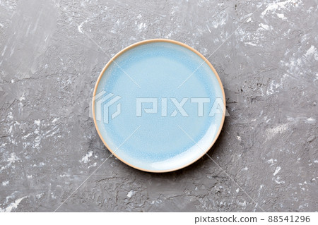 Top view of empty blue plate on cement background. Empty space for your design Top view of empty blue plate on cement background. Empty space for your design 88541296