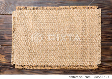 Top view of brown tablecloth for food on wooden background. Empty space for your design 88541324