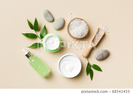 Coconut with jars of coconut oil and cosmetic cream on colored background. Top view. Free space for your text. Natural spa coconut cosmetics and organic treatment concept Coconut Spa composition Coconut with jars of coconut oil and cosmetic cream on colored background. Top view. Free space for your text. Natural spa coconut cosmetics and organic treatment concept Coconut Spa composition 88541455