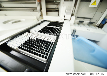 analyzer with containers with test tubes in close-up in a modern PCR laboratory analyzer with containers with test tubes in close-up in a modern PCR laboratory 88542107