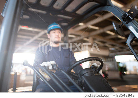 Male hand driving a forklift 88542942