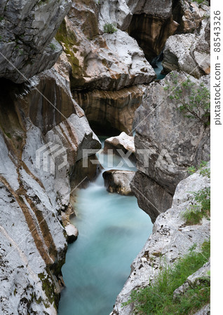 Blurred image of beautiful big gorge of soca river Blurred image of beautiful big gorge of soca river 88543326