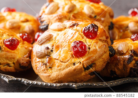 English Fat Rascals scones with dried fruits and almonds close-up in a plate. horizontal 88545182