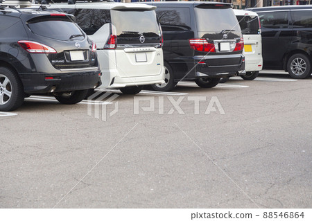 Cars lined up in a parking lot 88546864
