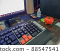 Pomodoro timer in form of a red tomato laying on a wooden table 88547541