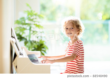 Child playing piano. Kids play music. Child playing piano. Kids play music. 88548490