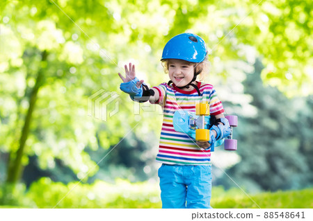 Child riding skateboard in summer park 88548641